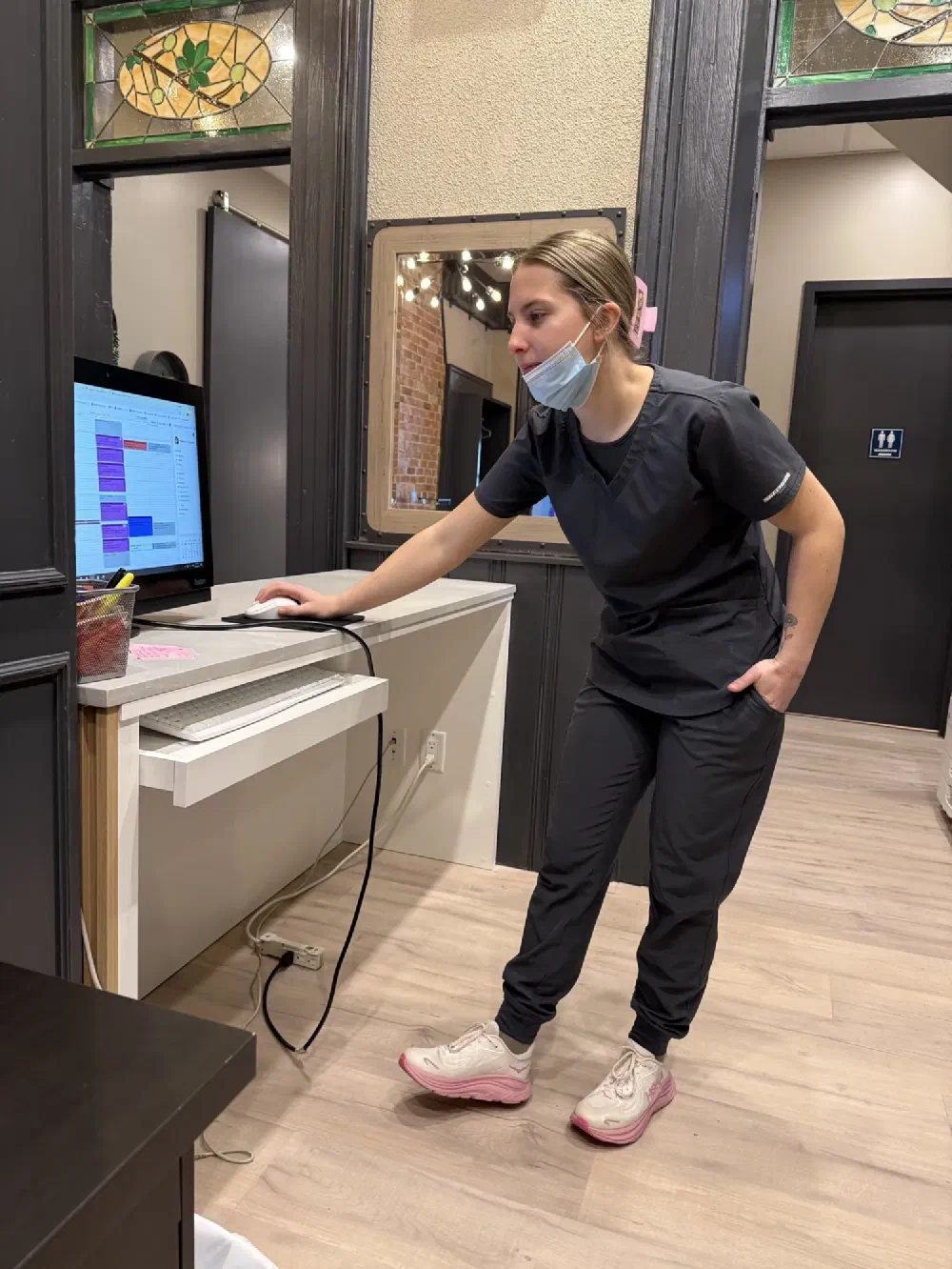 Cookstown Dental Centre team member reviewing the clinic schedule at a workstation