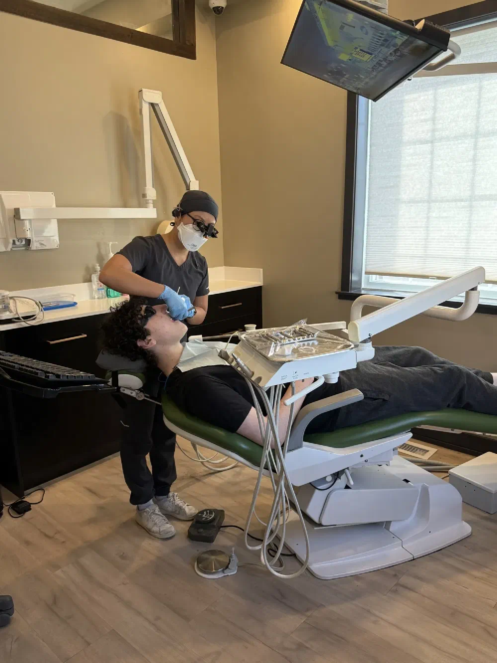 Dental hygienist providing patient care in a modern Cookstown treatment room