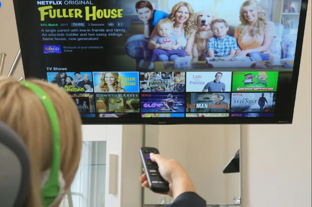 Patient choosing in-room entertainment from the dental chair