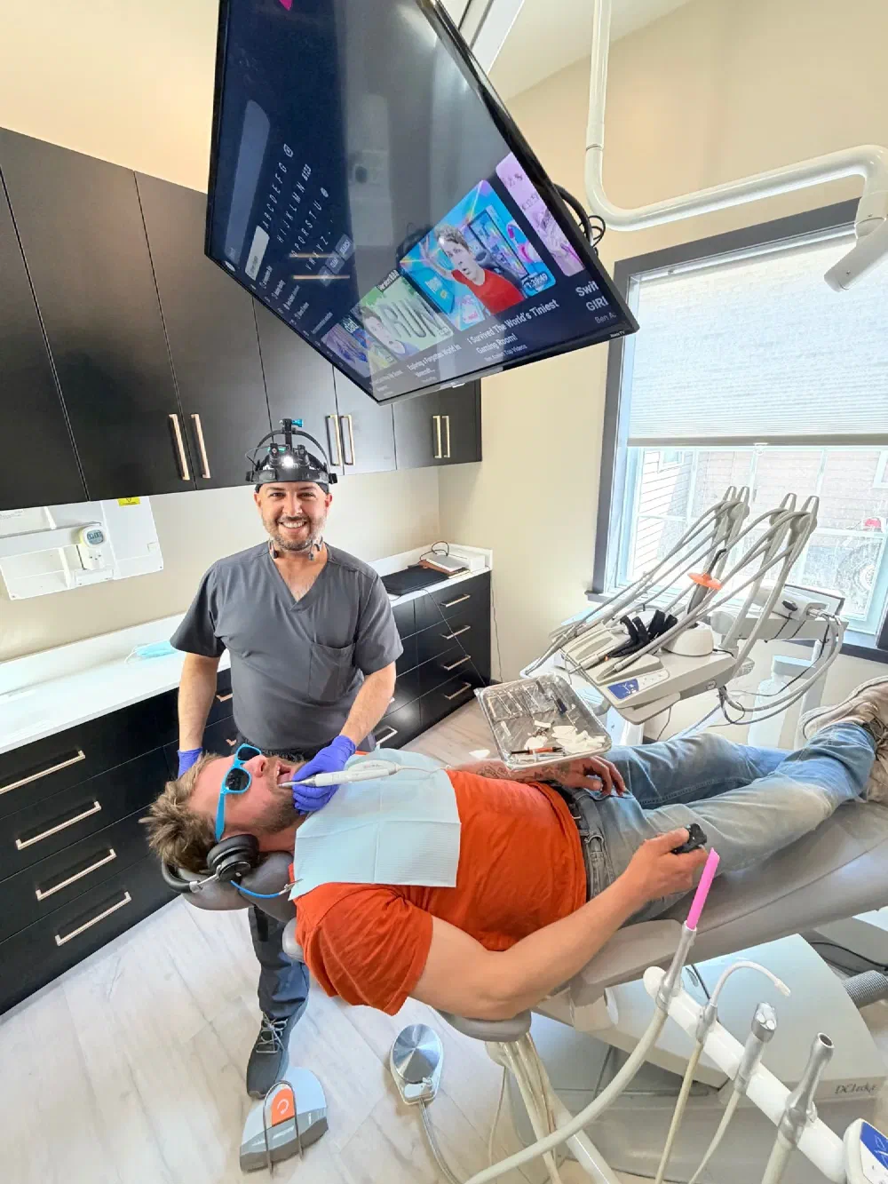 Cookstown dentist with a patient using in-room entertainment during treatment