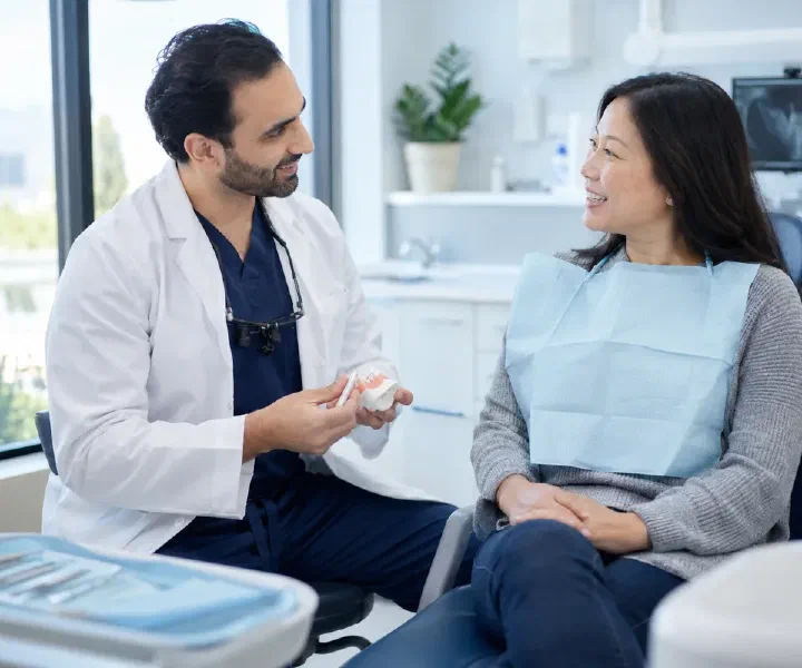 A patient returning to discuss pain after an extraction with a dentist