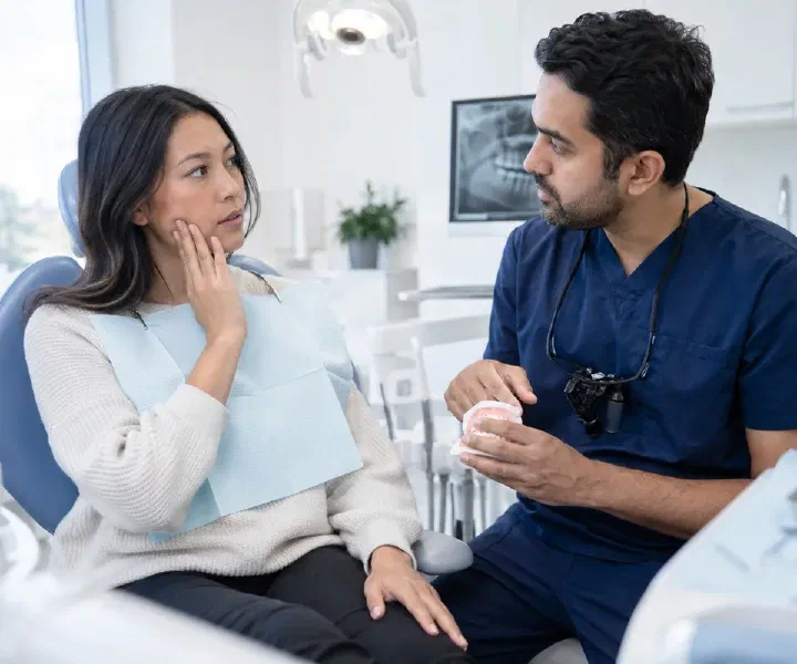 A patient describing facial swelling symptoms during a focused dental consultation