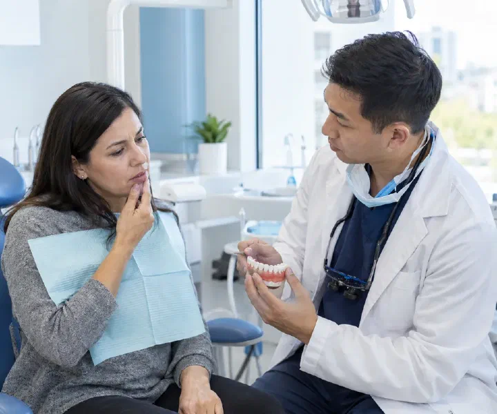 A dentist listening to a patient describe a localized gum swelling