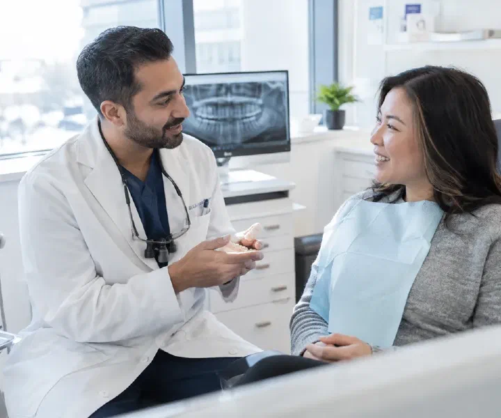 Patient discussing a post-treatment concern with a dentist reviewing appointment notes