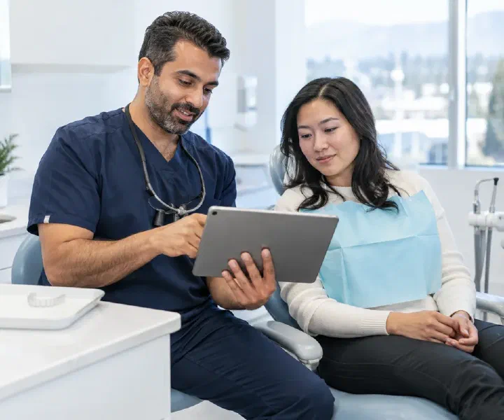 Patient discussing coordinated sleep care with a dentist reviewing medical and dental records