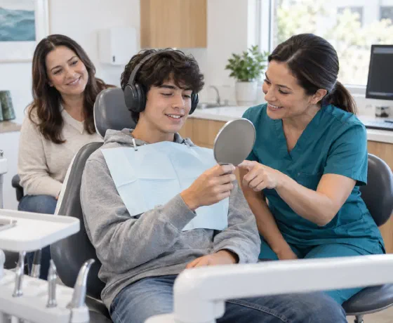 A patient using headphones and a mirror during a dental conversation
