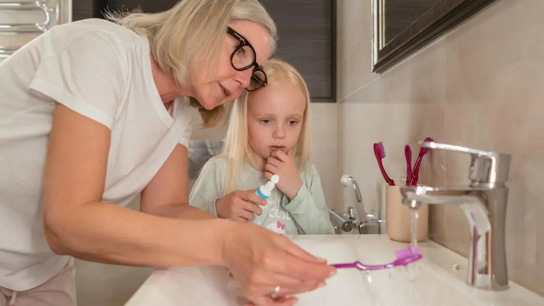 Grandmother assisting granddaughter with dental bridge maintenance, promoting oral hygiene in Cookstown.