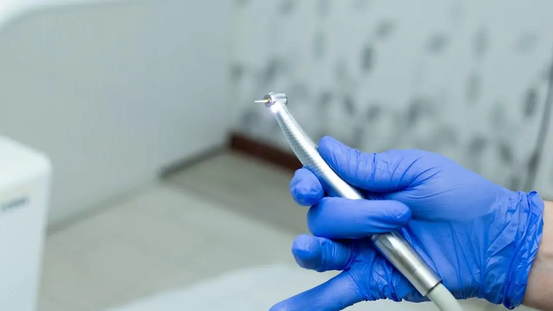 Dentist using drill at Cookstown clinic, illustrating common dental procedures.