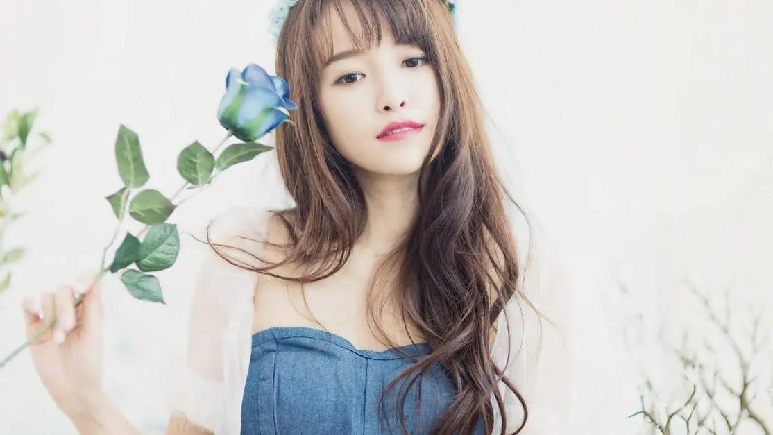 Woman with blue rose and flower crown, related to aftercare for dental veneers: what to avoid.