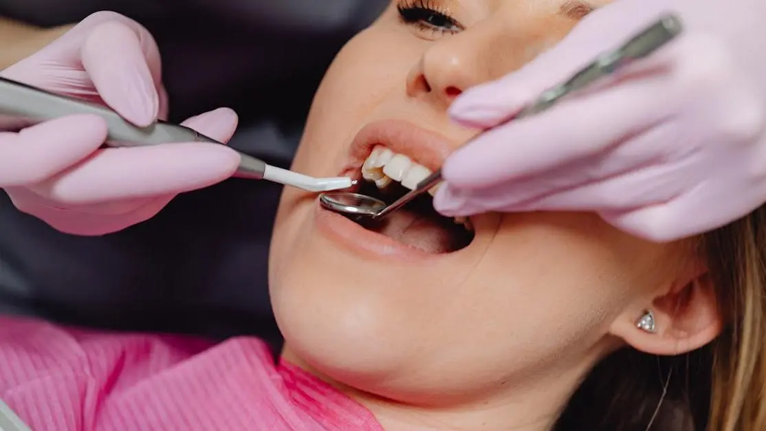 Woman receiving deep cleaning vs regular dental cleaning in a dental clinic.