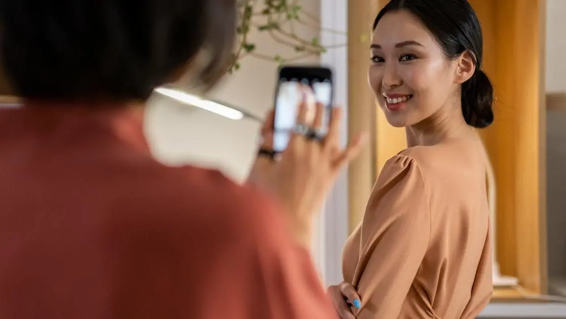 Asian woman in beige dress, pondering "is Invisalign better than veneers?"