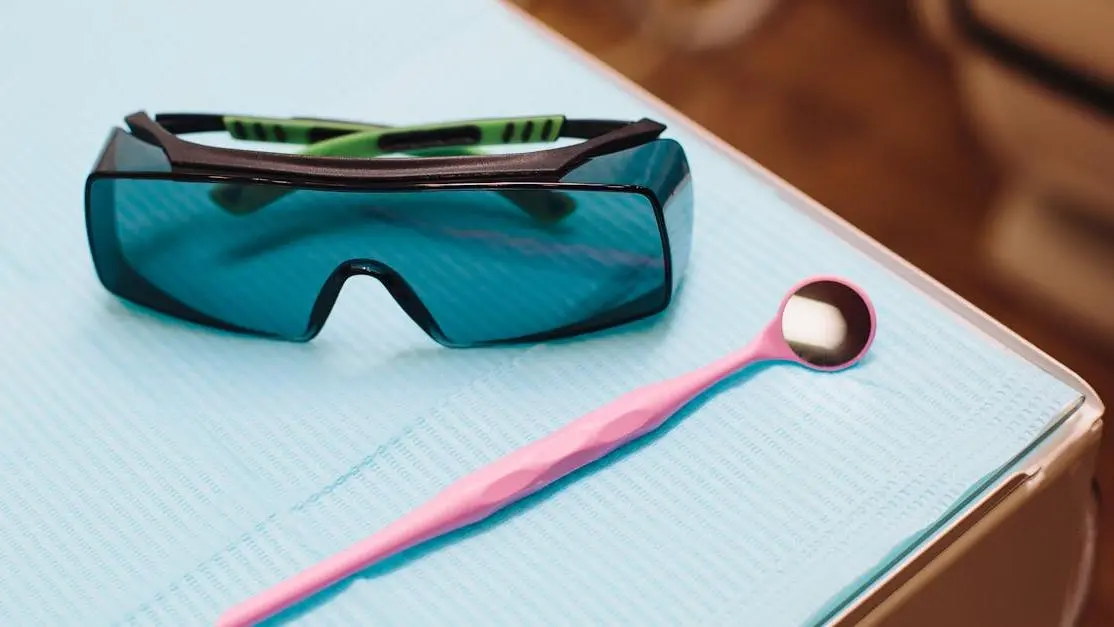 Dental tools and protective glasses in clinic underscore oral piercings and dental health risks.