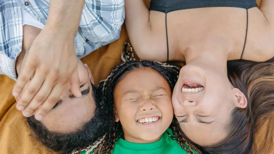 Smiling family relaxing outdoors, representing affordable dental care Thornton for happy families
