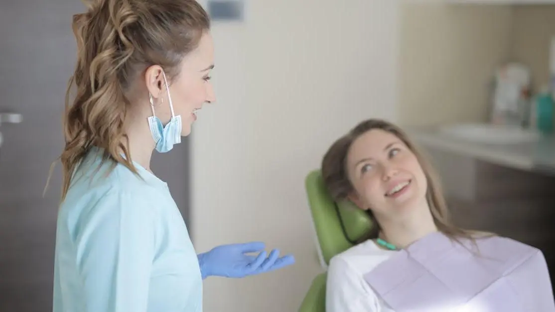 Dentist discussing gum disease treatment with patient in Thornton dental clinic
