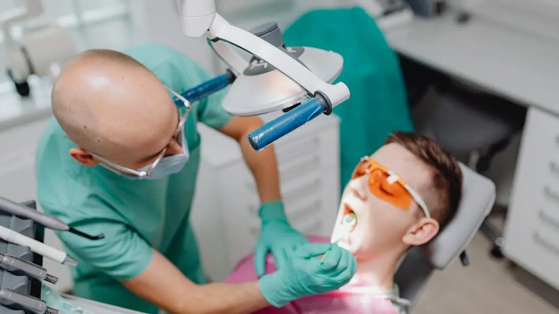 Dentist using pain-free laser dentistry for patient treatment in modern dental clinic.
