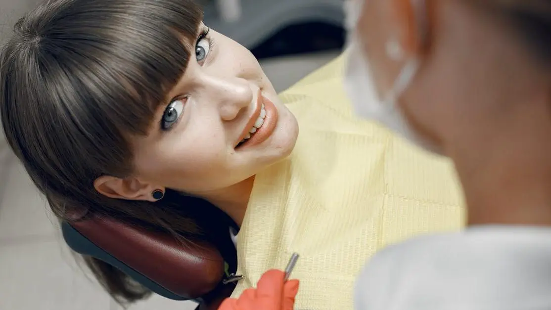 Smiling woman at dentist showcasing Thornton dental cleaning specials