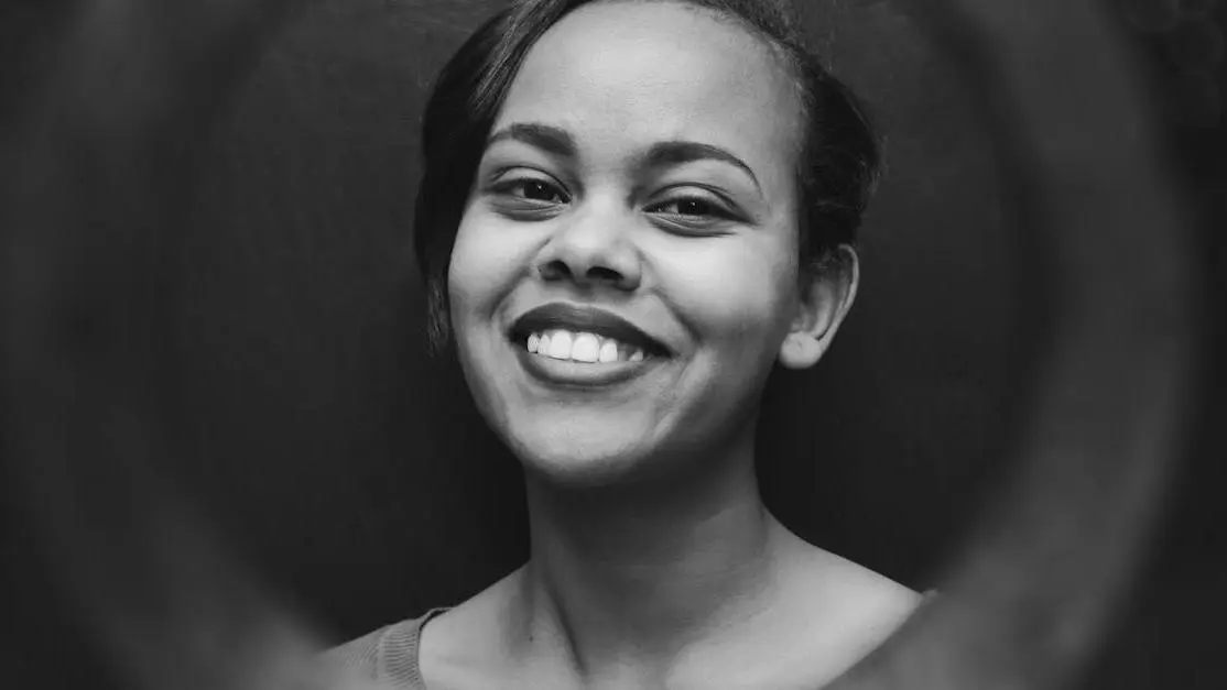 Woman smiling with healthy teeth, representing results from using toothpaste for sensitive teeth